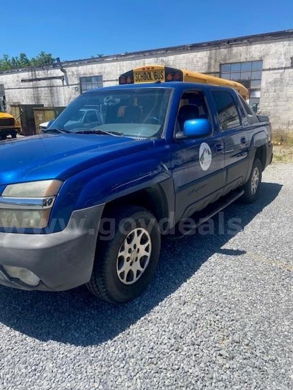 2003 Blue Chevy Avalanche pick up truck