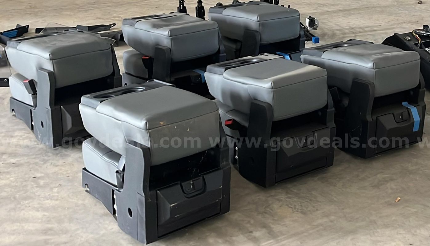 Six (6) OEM fold-down center jump seat/center console assemblies removed from police vehicles.