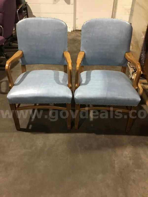 Two sky blue chairs; with light brown hardwood armrests "DH"