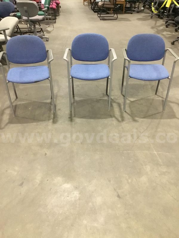 Three blue chairs; with dark gray padded armrests "DH"