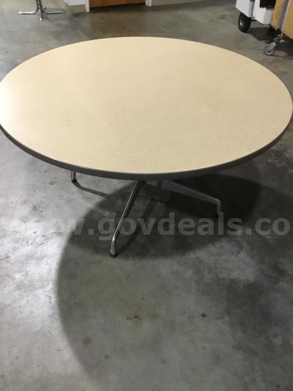 53 x 53 light oak round table; with four steel silver leg stands “DH”