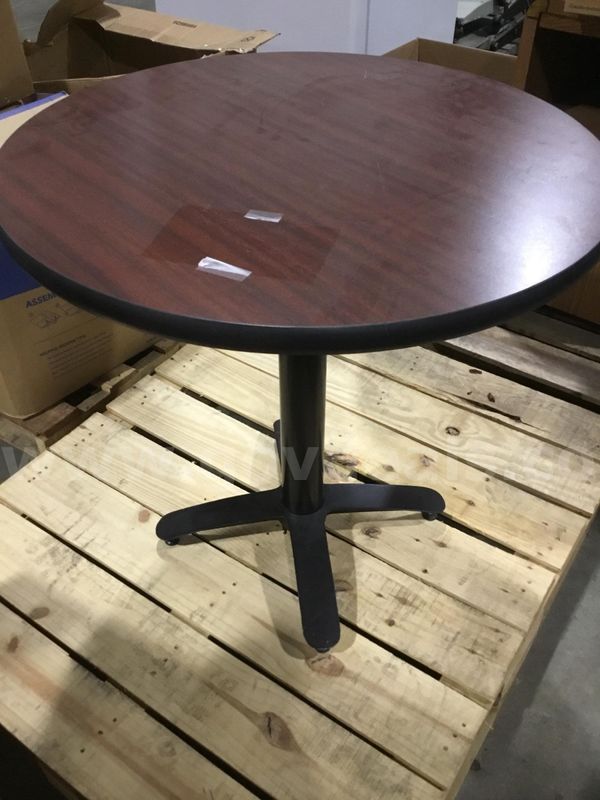 30 x 30 dark mahogany round table; with a black leg stand “DH”