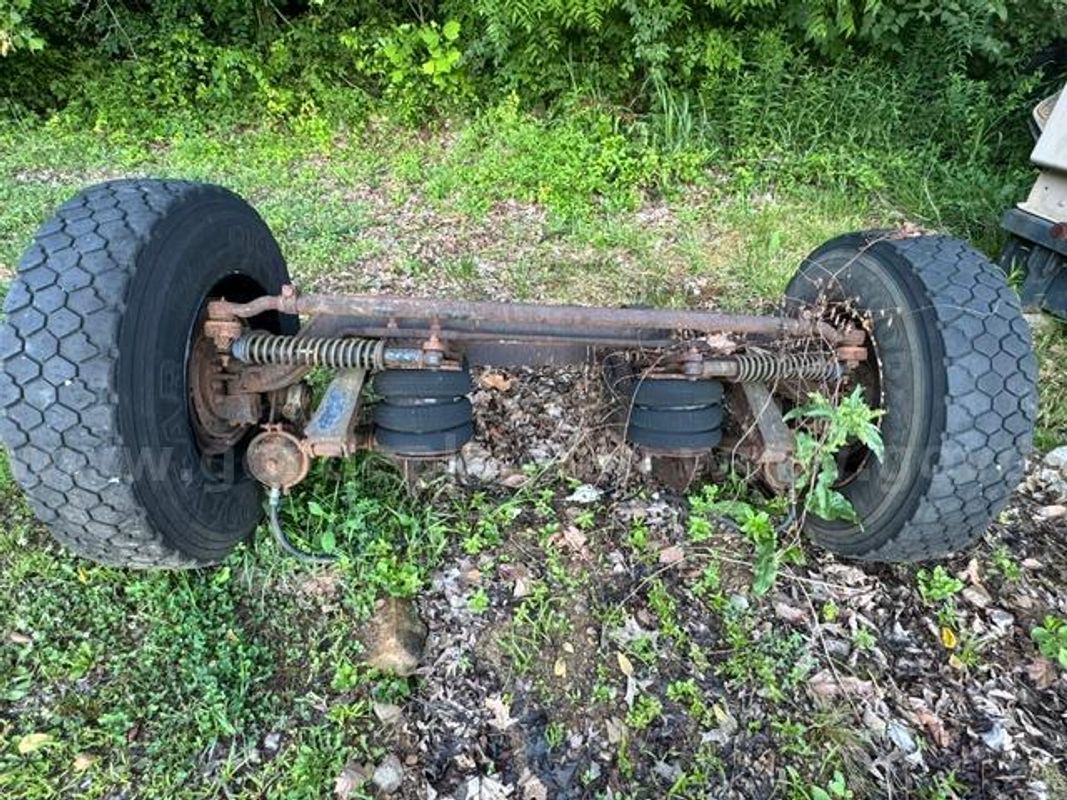 Watson & Chalin lift axle assembly, featuring a drop axle design with air springs.