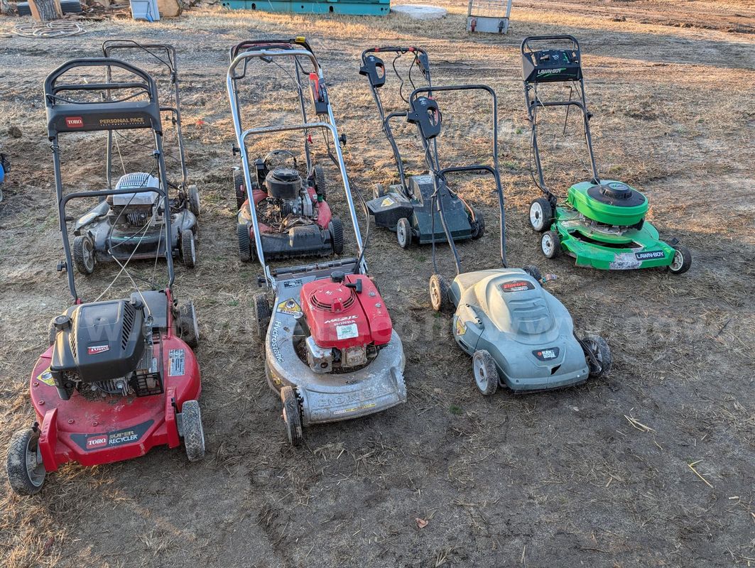 Seven Push Mowers.