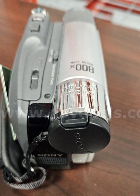 Lot of (1) Infinity Foot Pedal, (1) Sony Camcorder, and (1) Battery Pack.