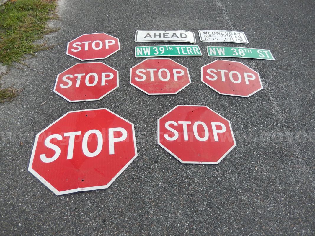 Used (6) Stop Signs, (2) Street Signs, (1) Ahead Sign, (1) Wednesday Times Sign