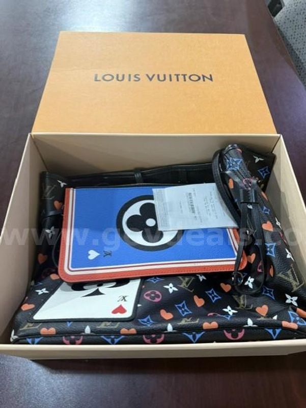 A Louis Vuitton Purse and Chance Purse in a box